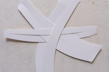 paper strips arranged in the shape of an asterisk 