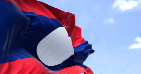 Detail of the national flag of Laos waving in the wind on a clear day