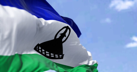 Detail of the national flag of Lesotho waving in the wind on a clear day