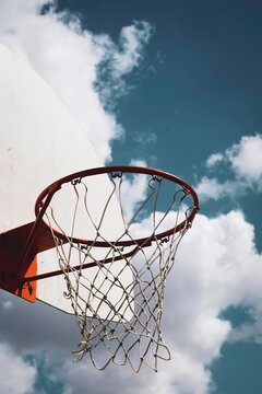 Outdoor basketball hoop and cloudy sky