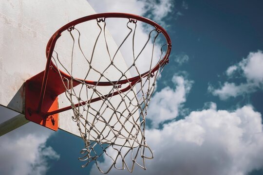 Outdoor basketball hoop and cloudy sky