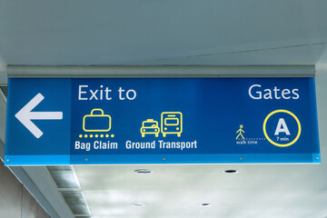 International Airport Sign Exit to Ground Transportation Baggage Claim Gates A in air terminal