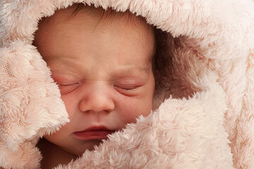 Beautiful Newborn baby girl sleeping , pink background	
