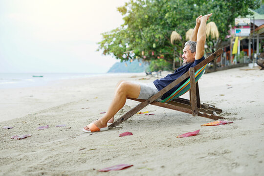 senior man lying on beach chair at the beach, concept elderly people relaxing,resting,travel,vacation,lifestyle,quality of life etc