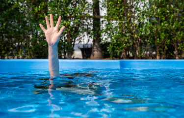 Hand of person drowing in swimming pool. Drowning is the process of experiencing respiratory...