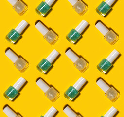 transparent glass bottles of blue and white nail polish on yellow background. Hard shadows. Kids cosmetic concept