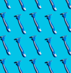 pattern with men's disposable shaving razors on a blue background, hair removal tools. The concept of man body care.