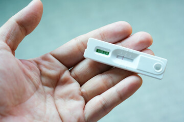 woman doctor holding a coronavirus (COVID-19) antigen test kit, tested positive for COVID-19