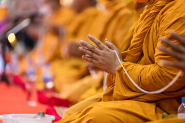 Pray of monks on ceremony of buddhist in Thailand. Many Buddha monk sit on the red carpet prepare to pray and doing Buddhist ceremony. - obrazy, fototapety, plakaty