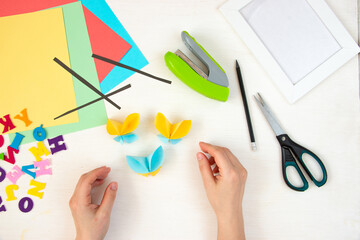 Butterflies with their own hands from colored paper. Step-by-step instructions, top view. Step 18.