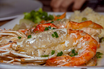 grilled lobster on a white plate with salad