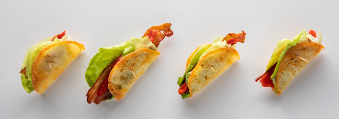 A row of provolone crisp appetizers against a light background.
