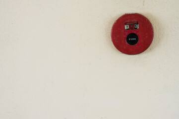 ire break glass alarm switch on the white cement wall texture