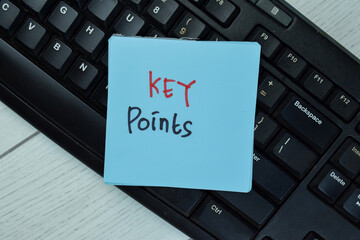 Key Points write on sticky notes isolated on Wooden Table.