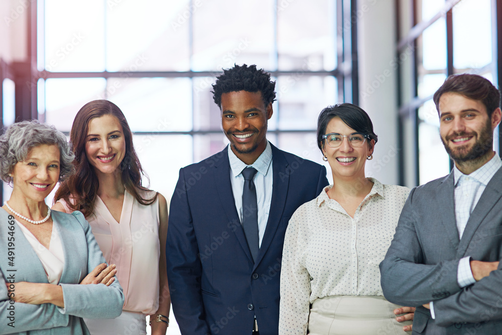 Wall mural Success built on diversity and ambition. Portrait of a diverse team of professionals standing together in a modern office.