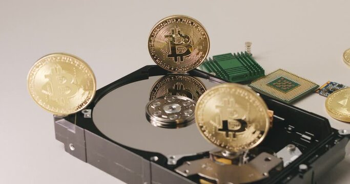 Bitcoin crypto currency with Hard Drive and computer parts. Modern hi tech financial technologies, upcoming crypto revolution concept