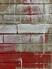 Paint smeared urban industrial vertical brick wall detail