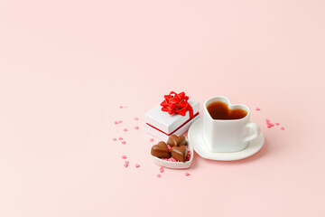 Mug with balck coffee, chocolate hearts, gift box on pink background. Flat lay composition. Romantic, St Valentines Day concept, banner for your site, mother day, mom, morning surprise