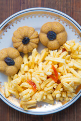 Traditional oriental sweet dessert zhent with raisins and chak chak in a plate on a wooden background