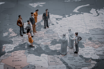 International miniature people stand around ukraine on world map. closeup.