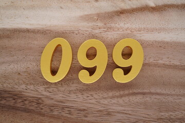 Golden Arabic numerals on a real brown and white wooden floor number 099