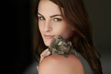 Just me and my pygmy marmosets. Cropped portrait of an attractive young woman posing with two pigmy...