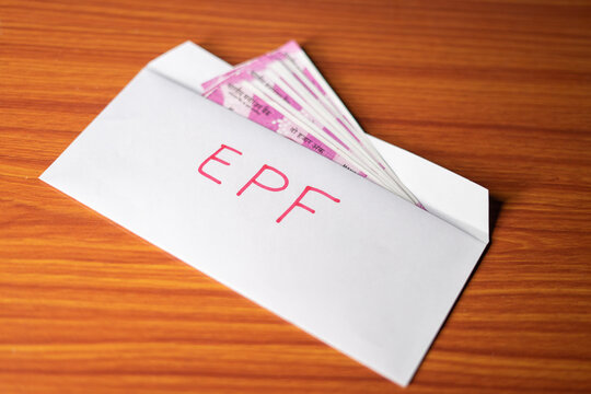 Epf money inside the envelope at table - concept of investment, employment benefit and growth