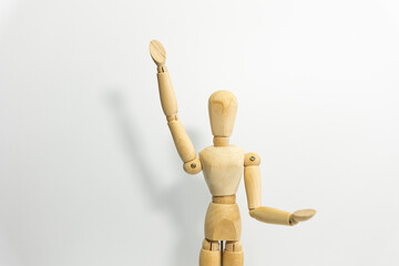 wooden mannequin rasing up its' hand