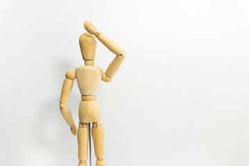 wooden mannequin touching it's head