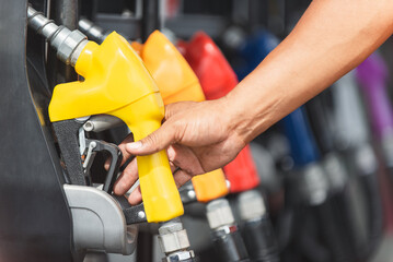 Car refueling on the petrol station. male employees controlled the fuel pump with Fuel nozzles...