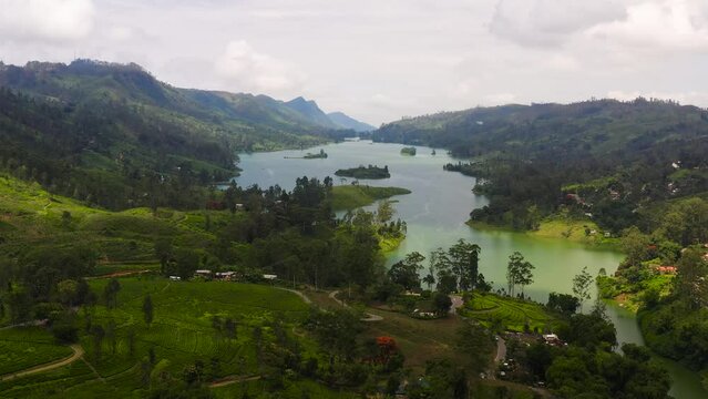 A lake among the hills with tea plantations in the mountains. Maskeliya, Castlereigh, Sri Lanka.