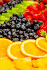 Fototapeta na wymiar Fresh fruits concept, Arrangement of orange kiwi and assorted berry as background
