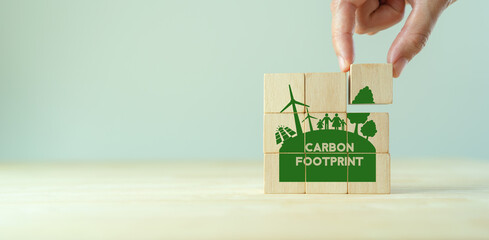 Carbon Footprint, zero emission concept. Carbon ecological footprint symbols on wooden cubes with...