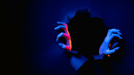 Night terror. Haunted banner. Evil ghost. Red blue neon light female monster hands breaking through...