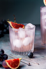 non alcoholic beverage with ice, figs and thyme garnish