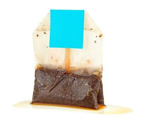 Used wet tea bag with tag isolated on a white background