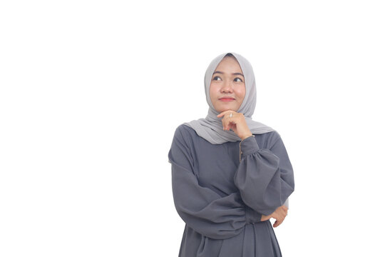 Smiling asian muslim woman while thinking something good. Isolated on white background