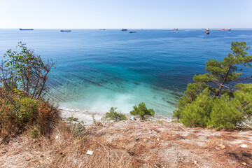 Beautiful summer landscape. View of the forest, rocks and sea coast. Hiking in scenic areas, the road to the wild beach. The resort town of Gelendzhik. Russia, Black sea coast