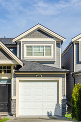 Garage door in luxury house with trees and nice landscape