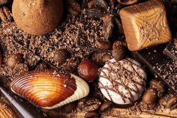 chocolate, cocoa, nuts and spices on wooden background
