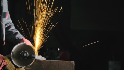 Forge workshop. Smithy manual production. Close up details of sparks, industrial worker using angle...