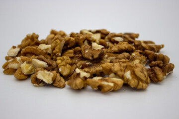 Peeled walnuts on white background