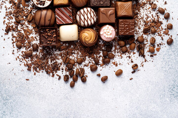 Chocolate candies and chocolate pieces pile for background