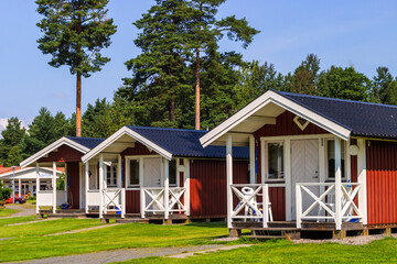 Red Holiday cottages on a camping ground - obrazy, fototapety, plakaty