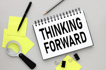 THINKING FORWARD. Gray background. text on open tekrade .many yellow stickers