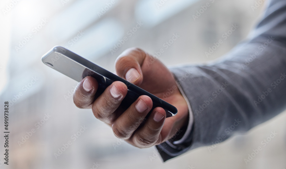Poster working on the go. shot of a businessperson using a smartphone.