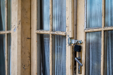 vintage wooden door with glass and peeled paint, peeled paint and wooden texture, door with padlock