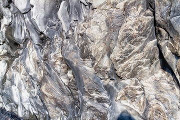 Reynisfjara rock formations and texture on a black sand beach in Iceland