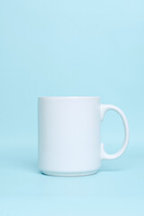 White plain porcelain mug for mock up isolated on pastel blue background