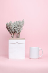 Paper bags for vases and porcelain mugs for mock up isolated on pink background